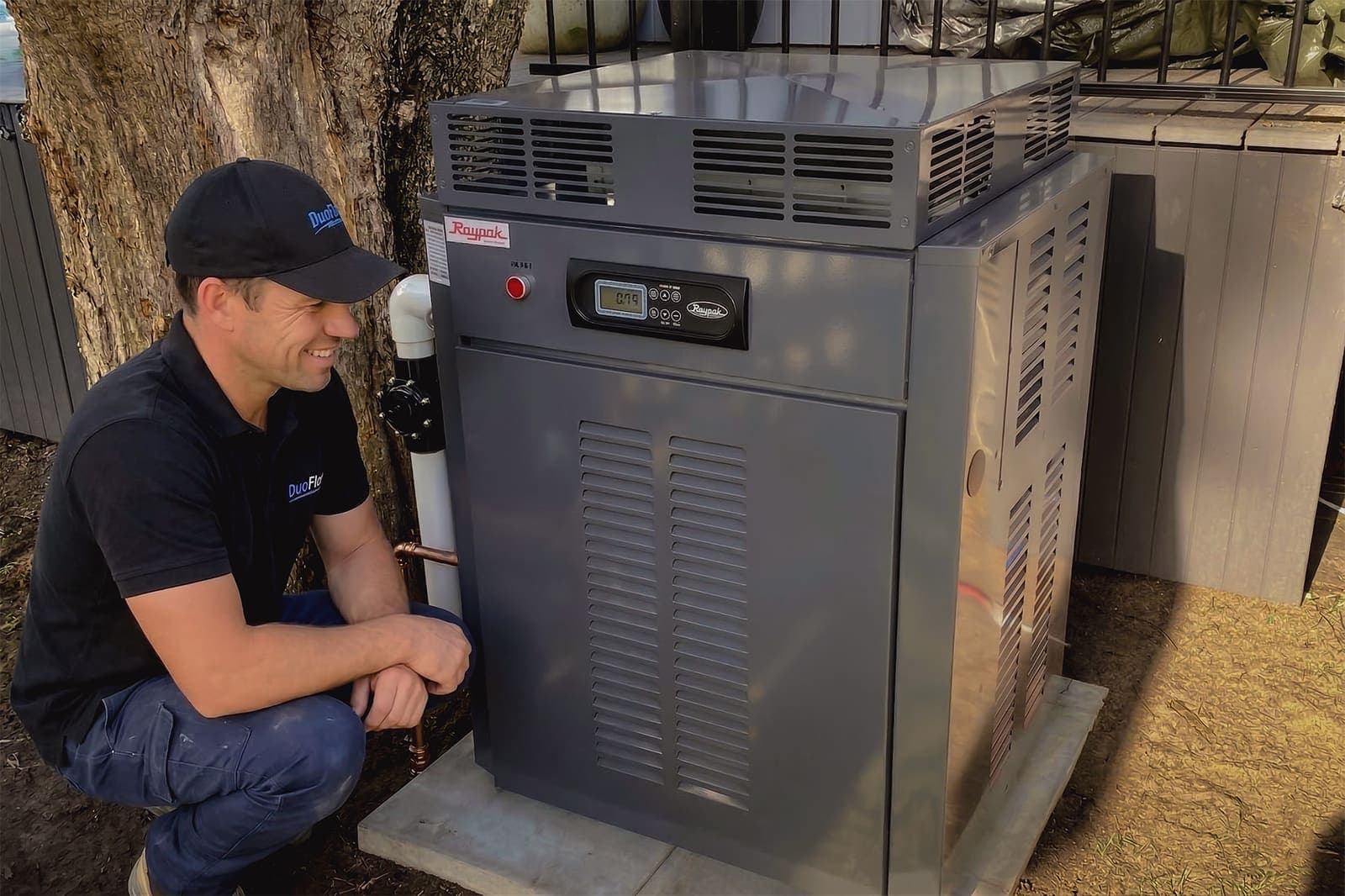 DuoFlow technician completing a pool heating service visit DuoFlow technician servicing a pool heating system